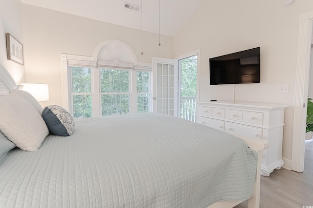 698 Riverwalk Dr Unit 304, Myrtle Beach, SC 29579 - bedroom with vaulted ceiling, light wood-type flooring, baseboards, and access to exterior