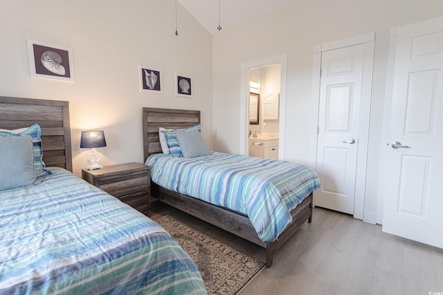 698 Riverwalk Dr Unit 304, Myrtle Beach, SC 29579 - bedroom featuring light wood finished floors, lofted ceiling, and ensuite bath