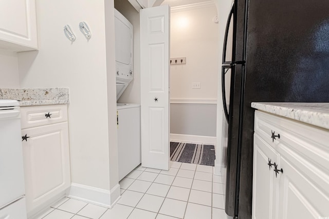 698 Riverwalk Dr Unit 304, Myrtle Beach, SC 29579 - washroom with estacked washer and dryer, light tile patterned flooring, and baseboards