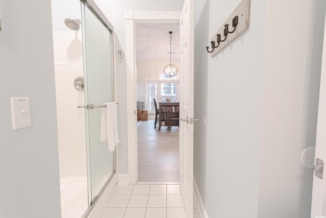 698 Riverwalk Dr Unit 304, Myrtle Beach, SC 29579 - hallway featuring light tile patterned floors, a chandelier, and baseboards