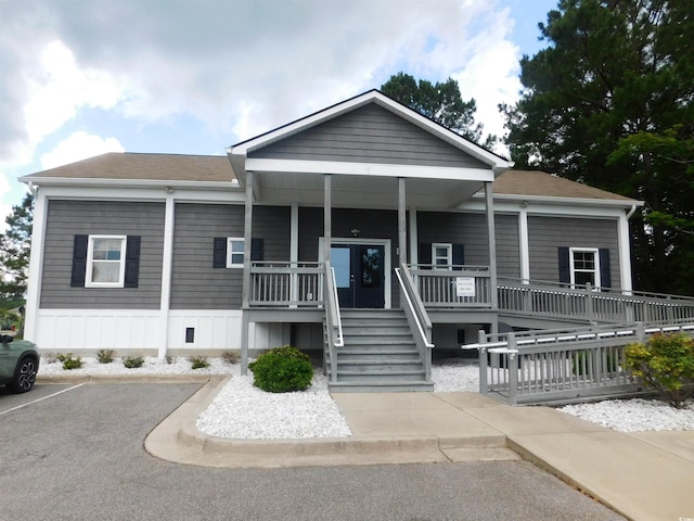 401 Quinta St, Longs, SC 29568 - view of front of property featuring a porch, stairway, uncovered parking, and a shingled roof