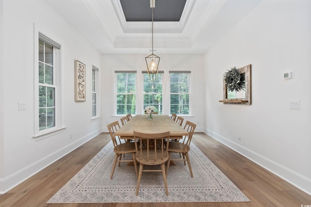 1058 E Isle Of Palms Ave, Myrtle Beach, SC 29579 - dining room featuring a tray ceiling, wood finished floors, and crown molding