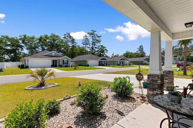125 Foxford Dr, Conway, SC 29526 - porch with curved driveway, a yard, a residential view, and an attached garage