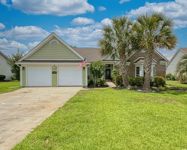 1635 Southwood Dr, Surfside Beach, SC 29575 - view of front of house featuring a garage, concrete driveway, and a front lawn