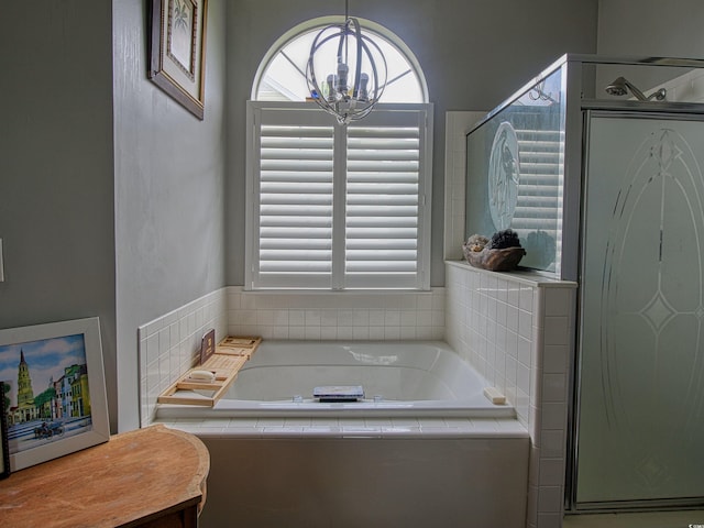 1635 Southwood Dr, Surfside Beach, SC 29575 - bathroom featuring a garden tub, a chandelier, and a stall shower