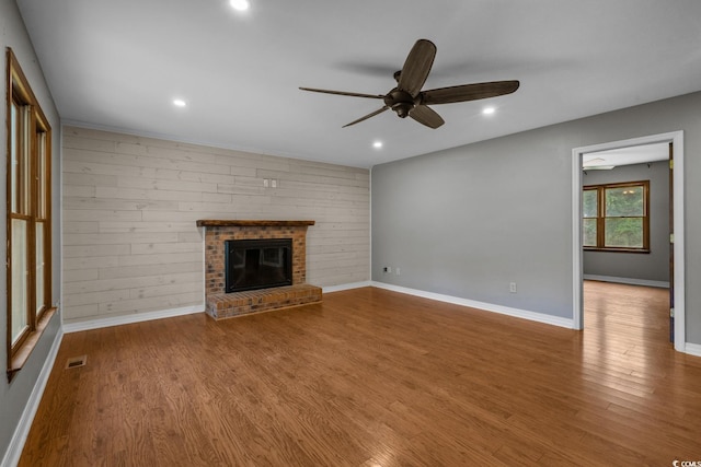 124 Wicklow Way, Pawleys Island, SC 29585 - unfurnished living room with ceiling fan, wood finished floors, a fireplace, recessed lighting, and baseboards