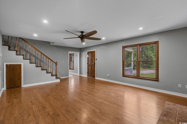 124 Wicklow Way, Pawleys Island, SC 29585 - unfurnished living room with a ceiling fan, wood finished floors, recessed lighting, stairway, and baseboards