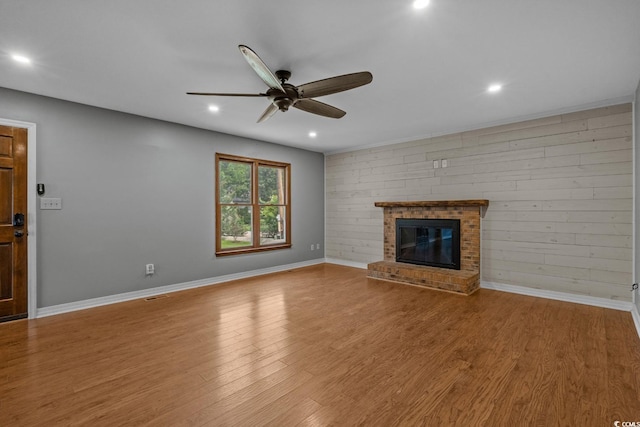 124 Wicklow Way, Pawleys Island, SC 29585 - unfurnished living room with a ceiling fan, a fireplace, wood finished floors, recessed lighting, and baseboards