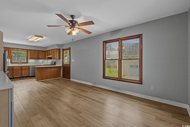 124 Wicklow Way, Pawleys Island, SC 29585 - kitchen with brown cabinets, stainless steel appliances, light countertops, and light wood-style flooring