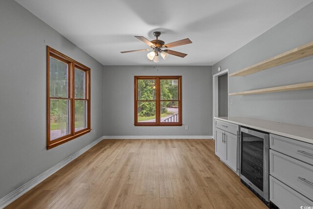 124 Wicklow Way, Pawleys Island, SC 29585 - bar area with beverage cooler, light wood-style floors, baseboards, and ceiling fan