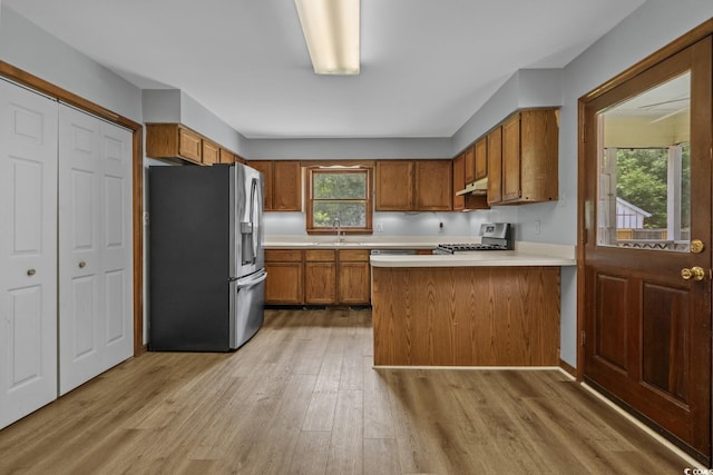 124 Wicklow Way, Pawleys Island, SC 29585 - kitchen featuring stainless steel fridge, brown cabinetry, range, under cabinet range hood, and light countertops