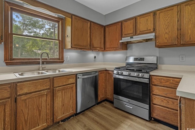 124 Wicklow Way, Pawleys Island, SC 29585 - kitchen featuring appliances with stainless steel finishes, under cabinet range hood, a sink, and brown cabinets
