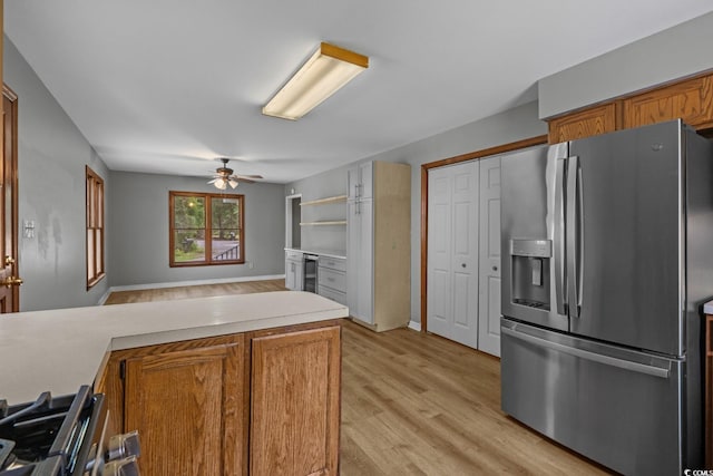 124 Wicklow Way, Pawleys Island, SC 29585 - kitchen with stainless steel refrigerator with ice dispenser, brown cabinetry, a ceiling fan, and light countertops