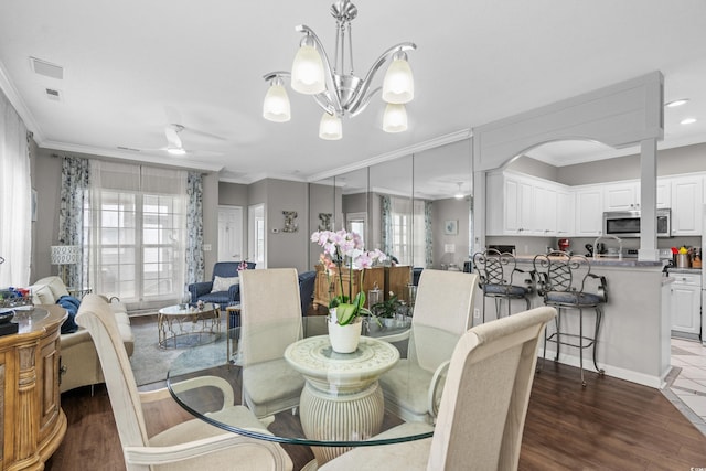 4648 Lightkeepers Way Unit 39A, Little River, SC 29566 - dining space with plenty of natural light, ornamental molding, dark wood-type flooring, a ceiling fan, and a chandelier