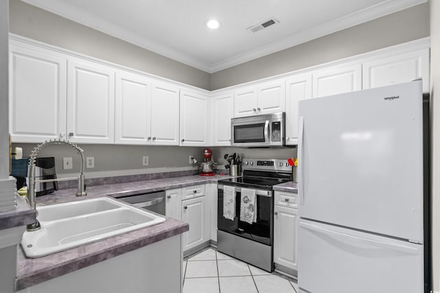 4648 Lightkeepers Way Unit 39A, Little River, SC 29566 - kitchen featuring appliances with stainless steel finishes, white cabinets, crown molding, light tile patterned flooring, and recessed lighting