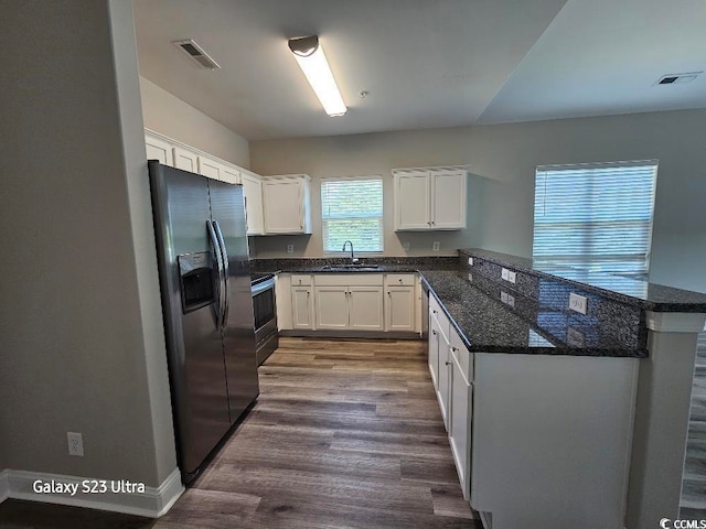 340 Kiskadee Loop, Conway, SC 29526 - kitchen featuring appliances with stainless steel finishes, a sink, a peninsula, dark wood-type flooring, and white cabinets