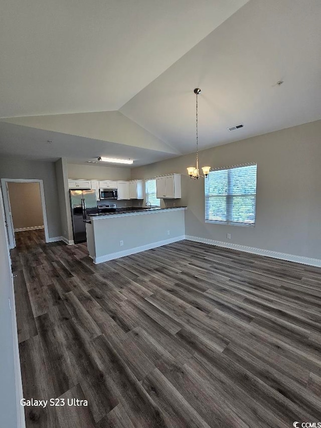 340 Kiskadee Loop, Conway, SC 29526 - kitchen with stainless steel appliances, open floor plan, white cabinets, dark countertops, and vaulted ceiling