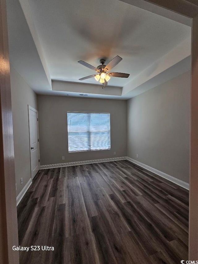 340 Kiskadee Loop, Conway, SC 29526 - spare room with a tray ceiling, dark wood finished floors, ceiling fan, and baseboards