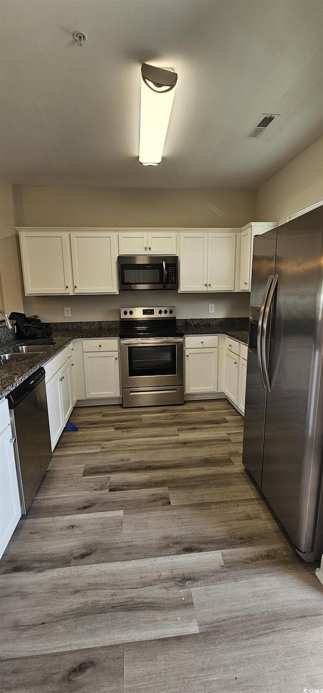 340 Kiskadee Loop, Conway, SC 29526 - kitchen with stainless steel appliances, a sink, dark wood-style flooring, and white cabinetry