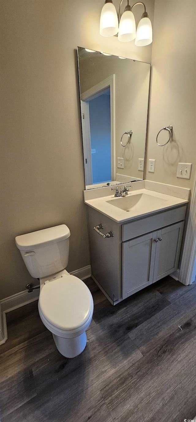 340 Kiskadee Loop, Conway, SC 29526 - half bathroom featuring wood finished floors, toilet, vanity, and baseboards