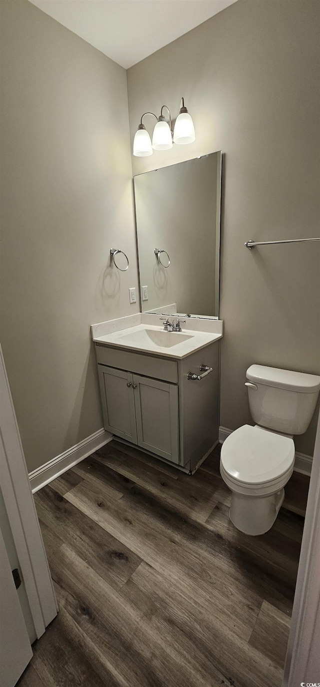 340 Kiskadee Loop, Conway, SC 29526 - half bathroom with vanity, toilet, wood finished floors, and baseboards