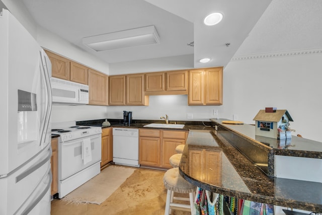 145 S Dunes Dr Unit 308, Pawleys Island, SC 29585 - kitchen featuring white appliances, a sink, a peninsula, and dark stone counters