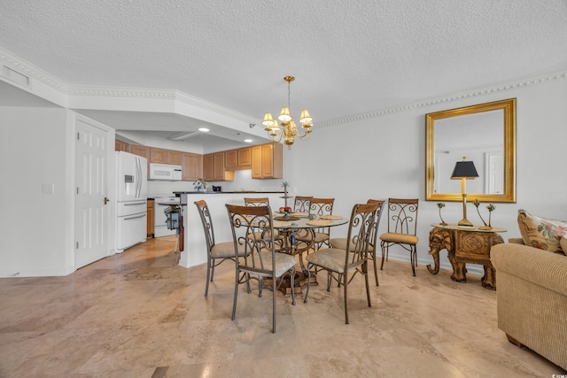 145 S Dunes Dr Unit 308, Pawleys Island, SC 29585 - dining area featuring a chandelier, a textured ceiling, and baseboards
