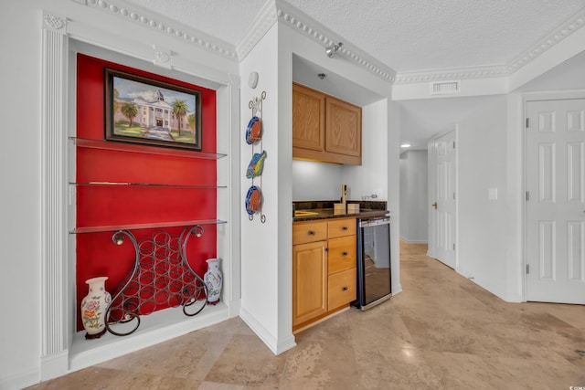 145 S Dunes Dr Unit 308, Pawleys Island, SC 29585 - kitchen with wine cooler, a textured ceiling, brown cabinetry, and baseboards