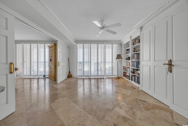 145 S Dunes Dr Unit 308, Pawleys Island, SC 29585 - spare room featuring a textured ceiling, a ceiling fan, and crown molding