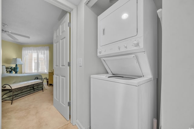 145 S Dunes Dr Unit 308, Pawleys Island, SC 29585 - laundry area with stacked washer / drying machine, light carpet, and a ceiling fan