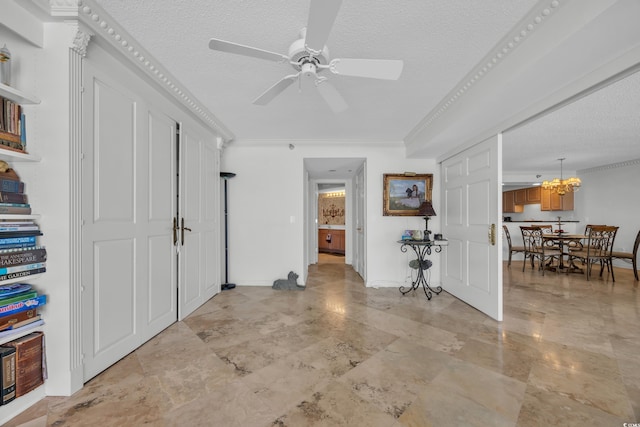 145 S Dunes Dr Unit 308, Pawleys Island, SC 29585 - foyer entrance featuring a textured ceiling, ceiling fan, crown molding, and a chandelier
