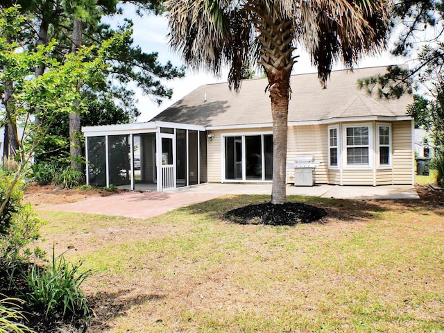 230 Vermillion Dr, Little River, SC 29566 - rear view of house featuring a sunroom, a patio area, and a lawn