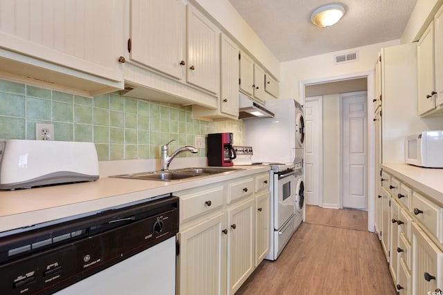 211 76th Ave N Unit A3, Myrtle Beach, SC 29572 - kitchen featuring white appliances, light countertops, under cabinet range hood, and backsplash