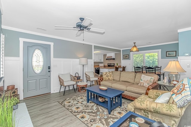4309 Beverly Ct, North Myrtle Beach, SC 29582 - living area with ceiling fan, wood finished floors, a wainscoted wall, and crown molding