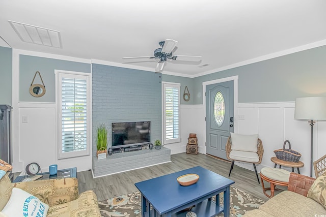 4309 Beverly Ct, North Myrtle Beach, SC 29582 - living area with a wainscoted wall, wood finished floors, a ceiling fan, a decorative wall, and crown molding