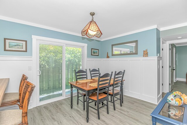 4309 Beverly Ct, North Myrtle Beach, SC 29582 - dining space with a wainscoted wall, light wood-type flooring, and a decorative wall