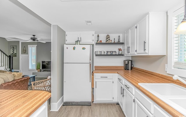 4309 Beverly Ct, North Myrtle Beach, SC 29582 - kitchen featuring freestanding refrigerator, open floor plan, white cabinetry, and a ceiling fan