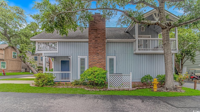 4309 Beverly Ct, North Myrtle Beach, SC 29582 - view of front of house featuring a balcony, board and batten siding, and a shingled roof