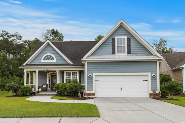 341 Bahama Dr, Murrells Inlet, SC 29576 - view of front of house featuring a front yard, concrete driveway, covered porch, and a garage