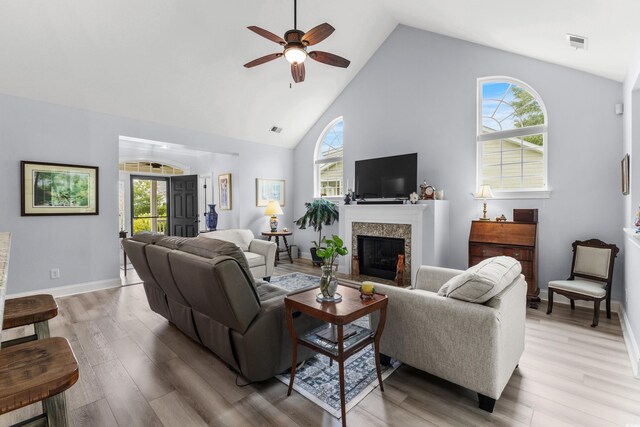 341 Bahama Dr, Murrells Inlet, SC 29576 - living area with a ceiling fan, high vaulted ceiling, light wood finished floors, a fireplace with raised hearth, and baseboards