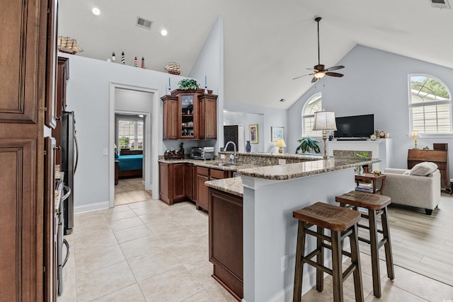 341 Bahama Dr, Murrells Inlet, SC 29576 - kitchen with a breakfast bar, a peninsula, open floor plan, ceiling fan, and plenty of natural light