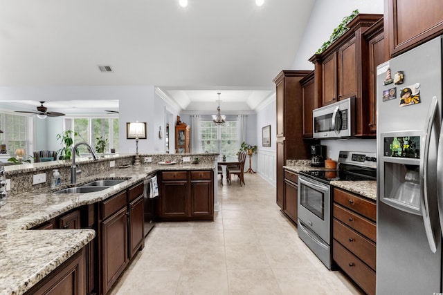 341 Bahama Dr, Murrells Inlet, SC 29576 - kitchen with stainless steel appliances, a sink, a chandelier, light stone counters, and light tile patterned flooring