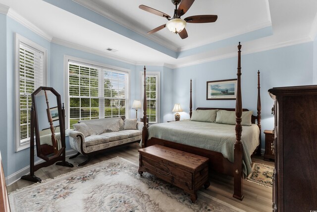 341 Bahama Dr, Murrells Inlet, SC 29576 - bedroom featuring wood finished floors, crown molding, a tray ceiling, ceiling fan, and baseboards