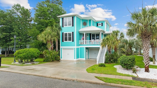 17 Trigger Fish Ln, Murrells Inlet, SC 29576 - coastal home with stairs, a garage, concrete driveway, and a porch