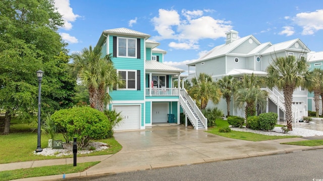 17 Trigger Fish Ln, Murrells Inlet, SC 29576 - beach home with stairway, a garage, driveway, metal roof, and a porch