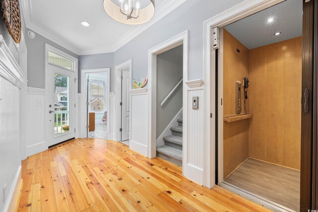 17 Trigger Fish Ln, Murrells Inlet, SC 29576 - entrance foyer featuring elevator, wood-type flooring, stairway, crown molding, and wainscoting