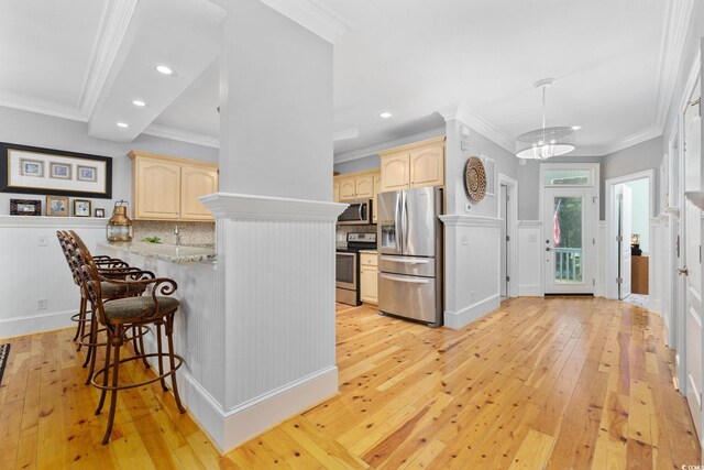 17 Trigger Fish Ln, Murrells Inlet, SC 29576 - kitchen with appliances with stainless steel finishes, light brown cabinets, light wood finished floors, a kitchen breakfast bar, and recessed lighting