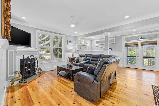 17 Trigger Fish Ln, Murrells Inlet, SC 29576 - living room featuring ornate columns, crown molding, a fireplace with flush hearth, light wood-style floors, and ceiling fan