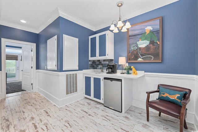 17 Trigger Fish Ln, Murrells Inlet, SC 29576 - kitchen featuring dishwashing machine, a chandelier, wainscoting, light countertops, and light wood-type flooring