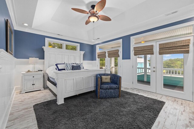17 Trigger Fish Ln, Murrells Inlet, SC 29576 - bedroom featuring access to outside, french doors, a raised ceiling, a wainscoted wall, and wood finished floors